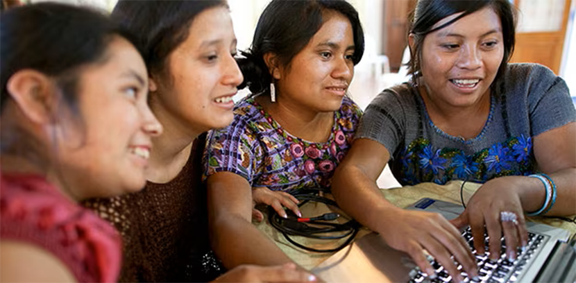 Girls around a computer