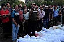 Palestinians with bodies